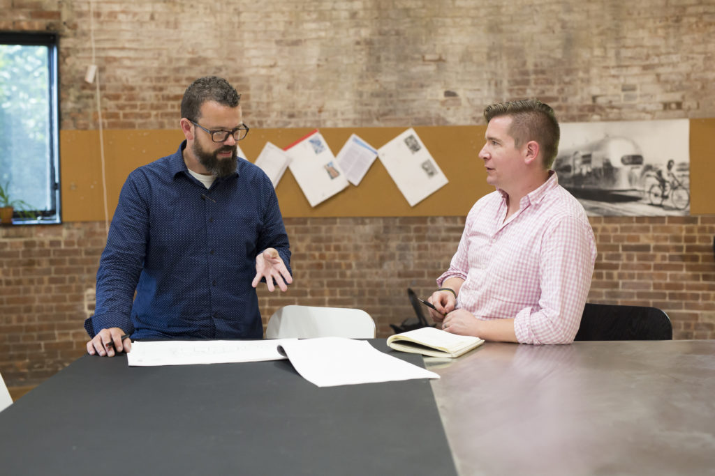 Jason and Eric discussing a project.